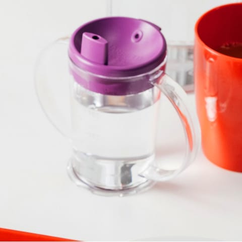 A clear graduated beaker with 2 handles and a purple spout.